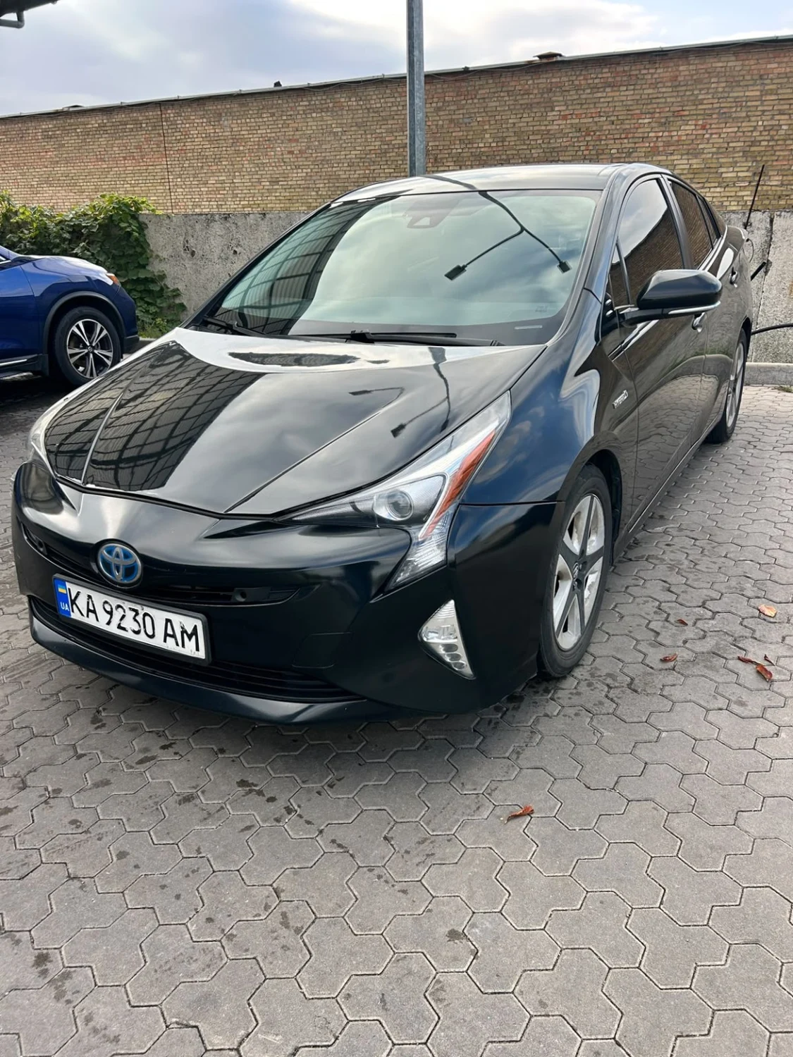 Black Toyota Prius, front three-quarter view